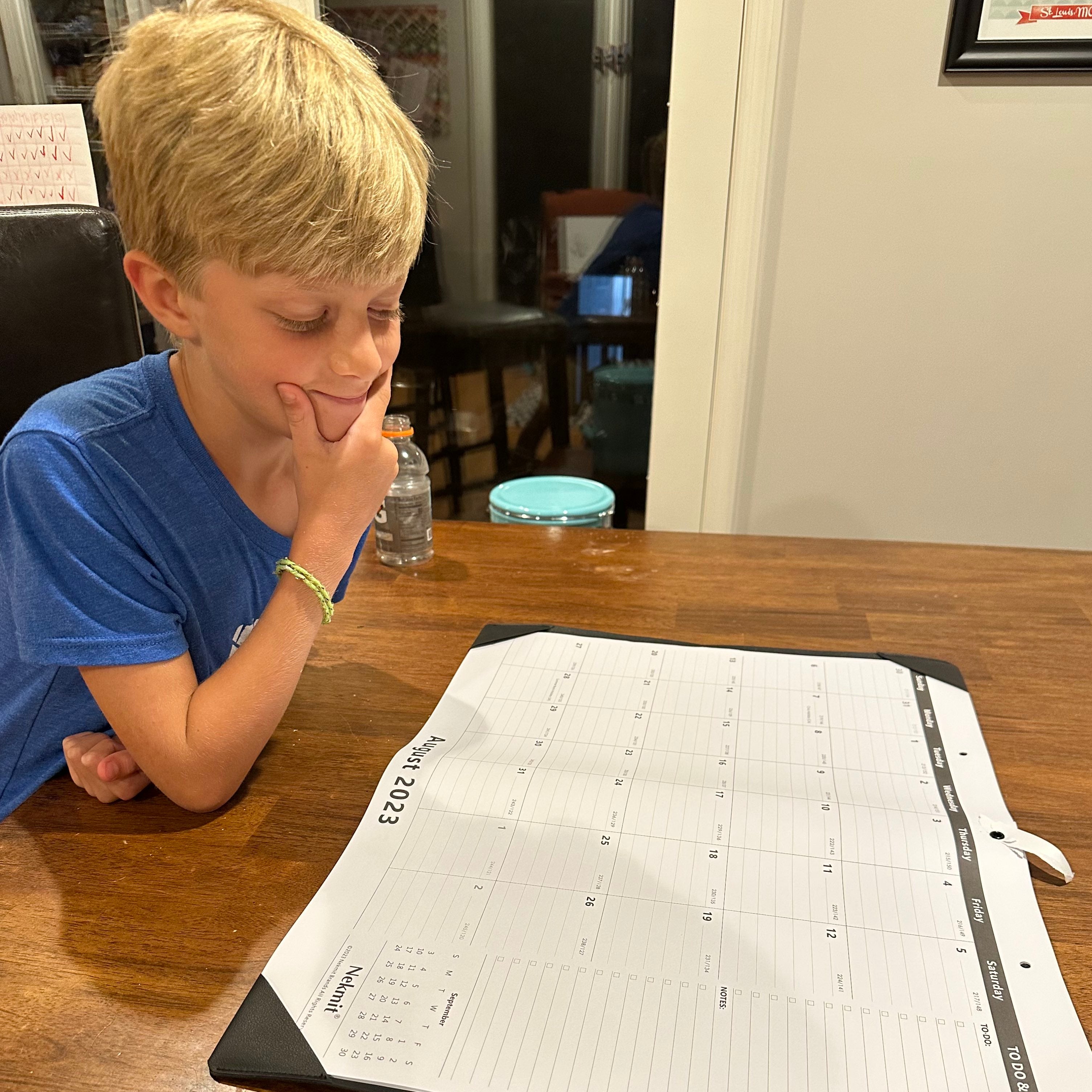 Calendar boy looking at calendar