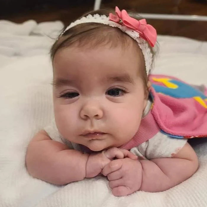 Photo of baby girl in her pink TinySuperheroes Cape