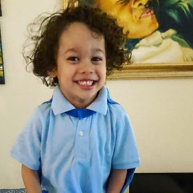 Photo of boy smiling with his blue TinySuperheroes Cape on