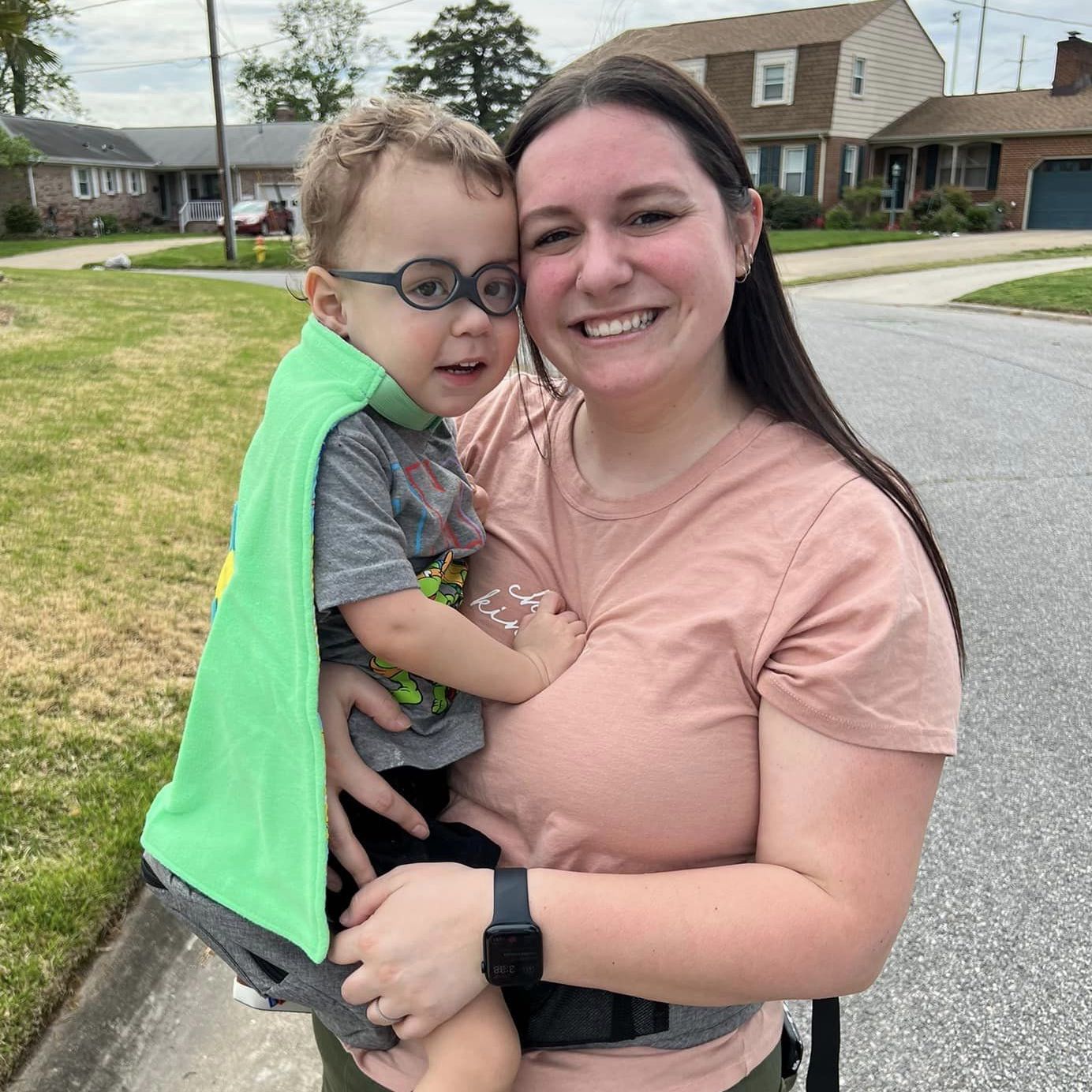 Girl standing showing off her red TinySuperheroes Cape