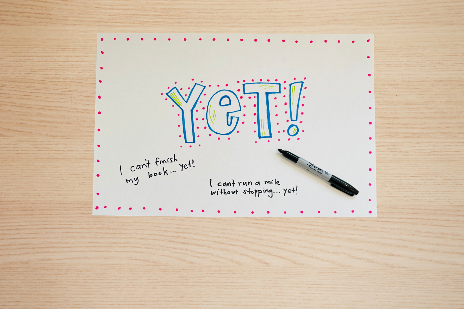 Photo of poster with things written on it around the colorful word 'Yet'